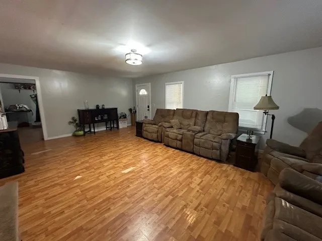 a large bedroom with a bed window and couch