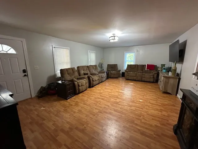 a bed room with furniture and a flat screen tv