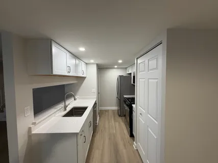 a kitchen with a sink a refrigerator and a stove