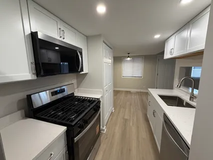 a kitchen that has a sink and a stove