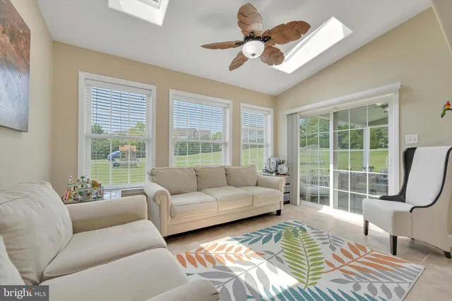 a view of a dining room and a kitchen with a table and chairs