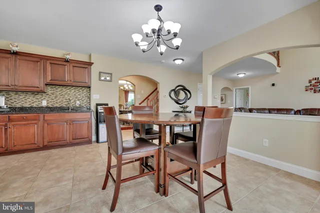 a kitchen with stainless steel appliances granite countertop a stove top oven a sink and dishwasher a refrigerator with wooden cabinets