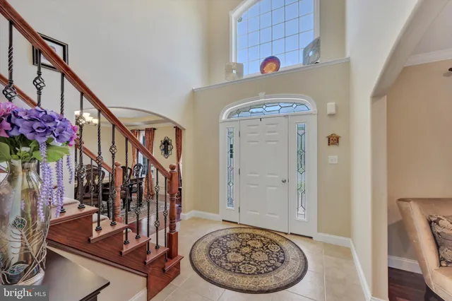 a view of entryway with a table and a chairs