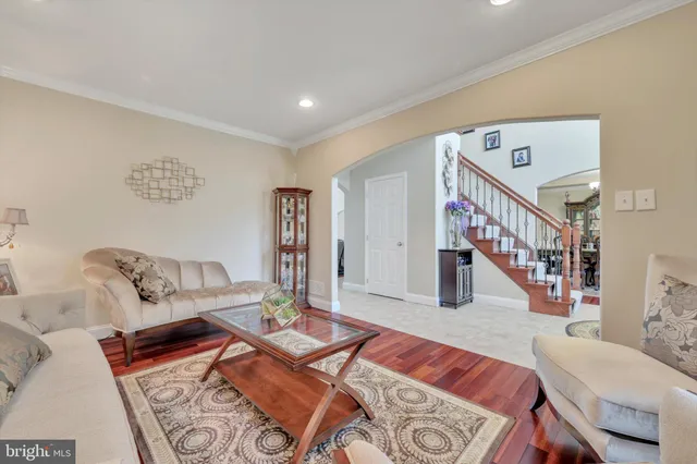 a dining room with furniture a chandelier and wooden floor