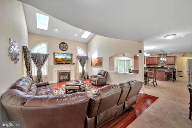 a living room with furniture a window and wooden floor