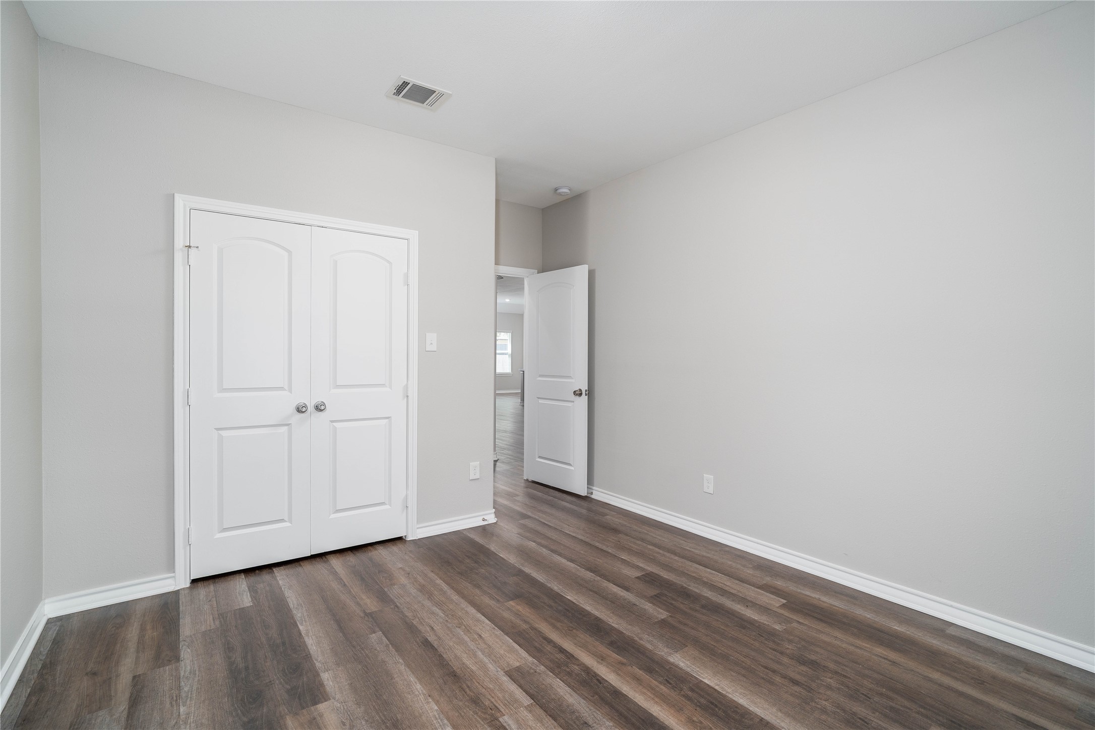 231 McCormick Street Columbus, TX 78934 - Photo 19 of 27 Bedroom – Spacious layout with ample wall space and a double-door closet, offering both comfort and functional storage.