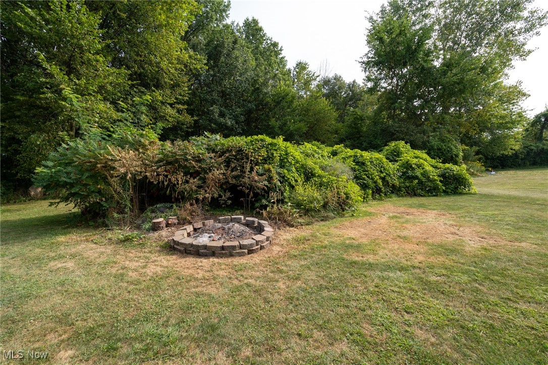 12345 Darrow Road Vermilion, OH 44089 - Photo 26 of 50 View of rear yard with a fire pit