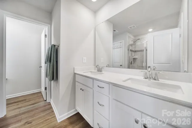 a bathroom with a double vanity sink and mirror