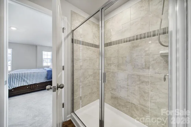 a bathroom with a shower and a glass door