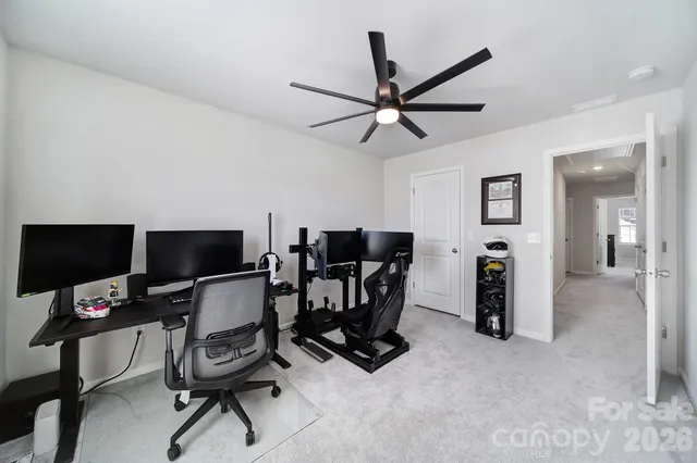 a view of a livingroom with workspace and a window
