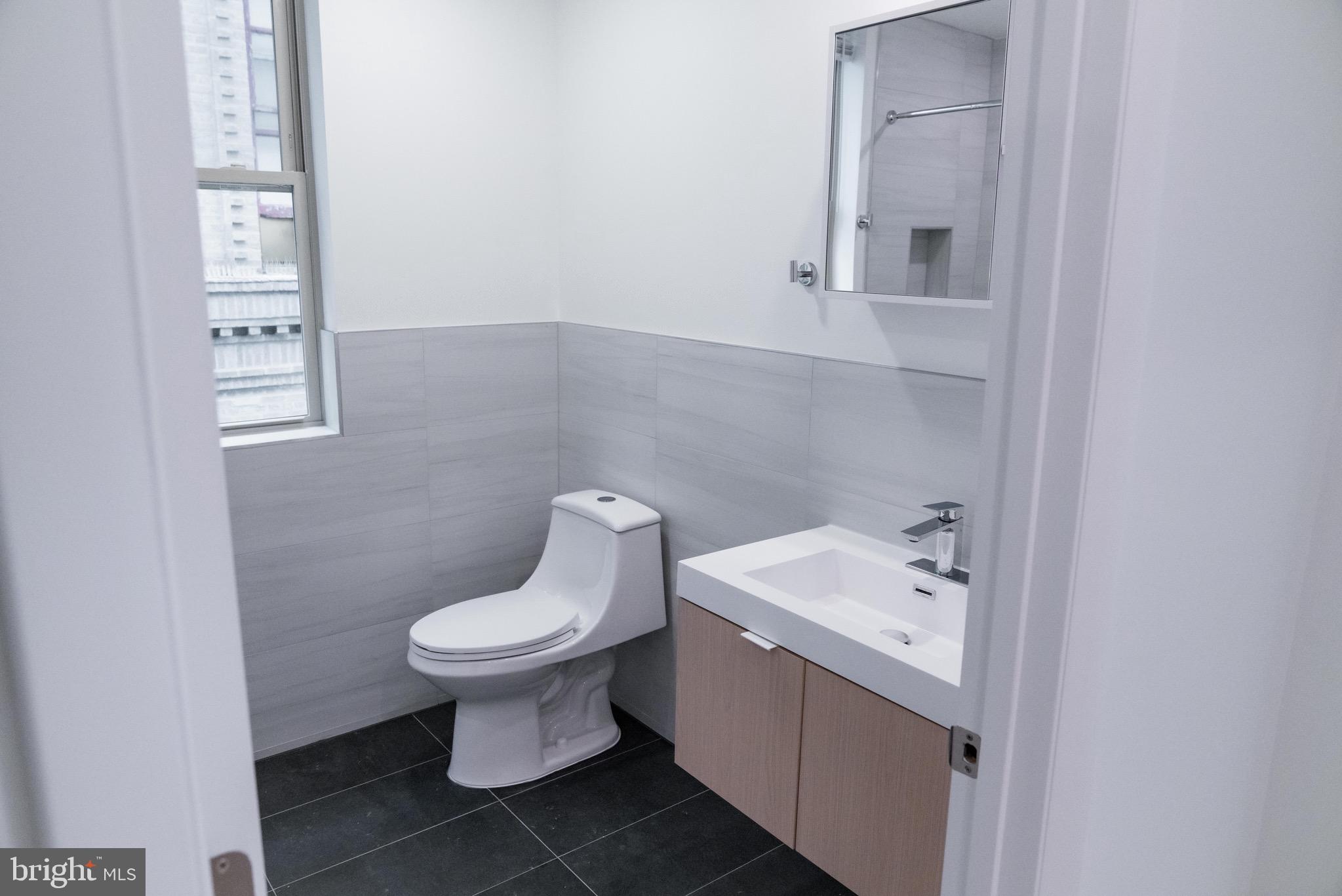 7248 Rising Sun Avenue, Unit 201 Philadelphia, PA 19111 - Photo 14 of 20 a white toilet sitting next to a bathroom sink