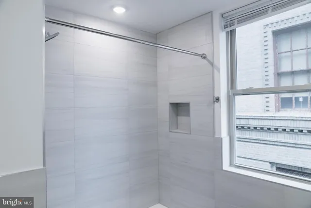 a bathroom with a shower and a sink