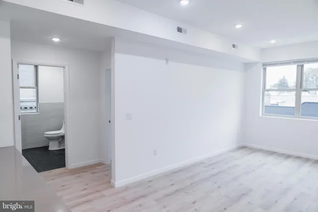 a view of an empty room and a bathroom