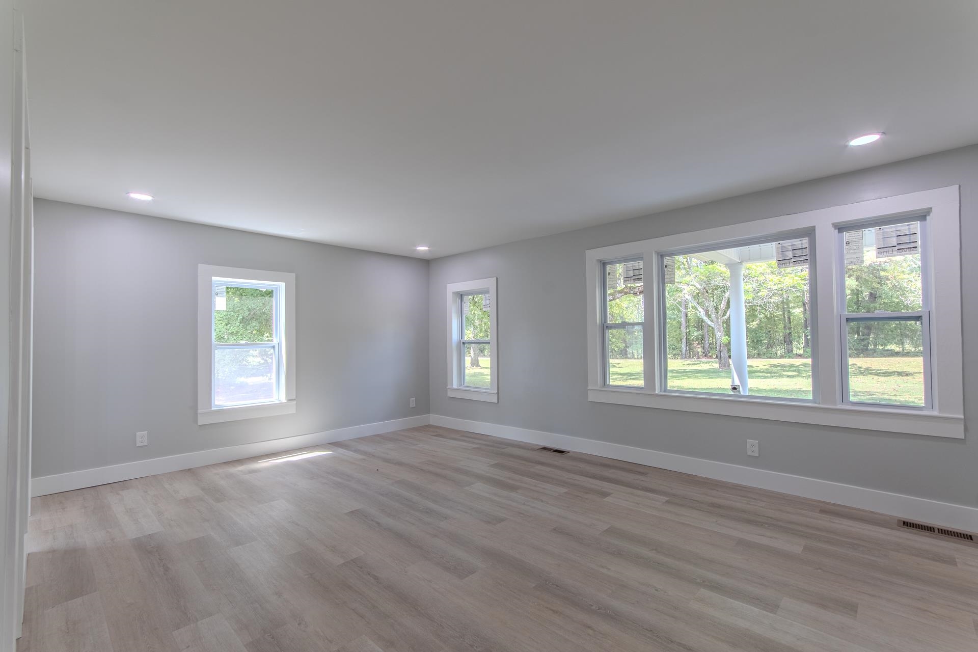 6800 Glendale Road Morris Chapel, TN 38361 - Photo 12 of 40 a view of an empty room with wooden floor and a window