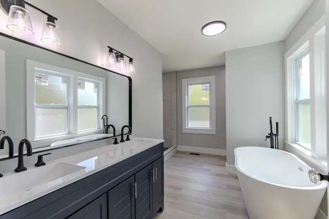 a bathroom with a double vanity sink and a bathtub
