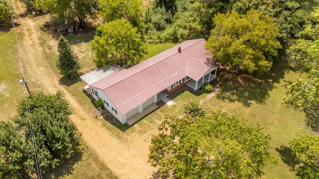 a aerial view of a house with a yard and lake view