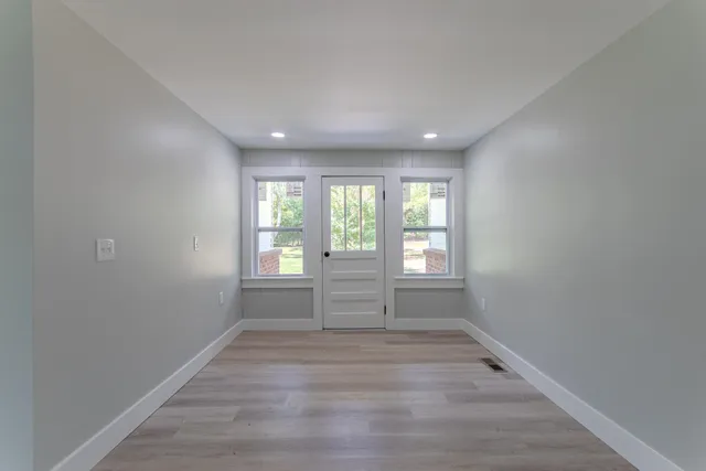 wooden floor in an empty room with a window