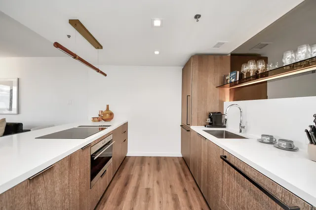 a kitchen with a sink a stove and cabinets