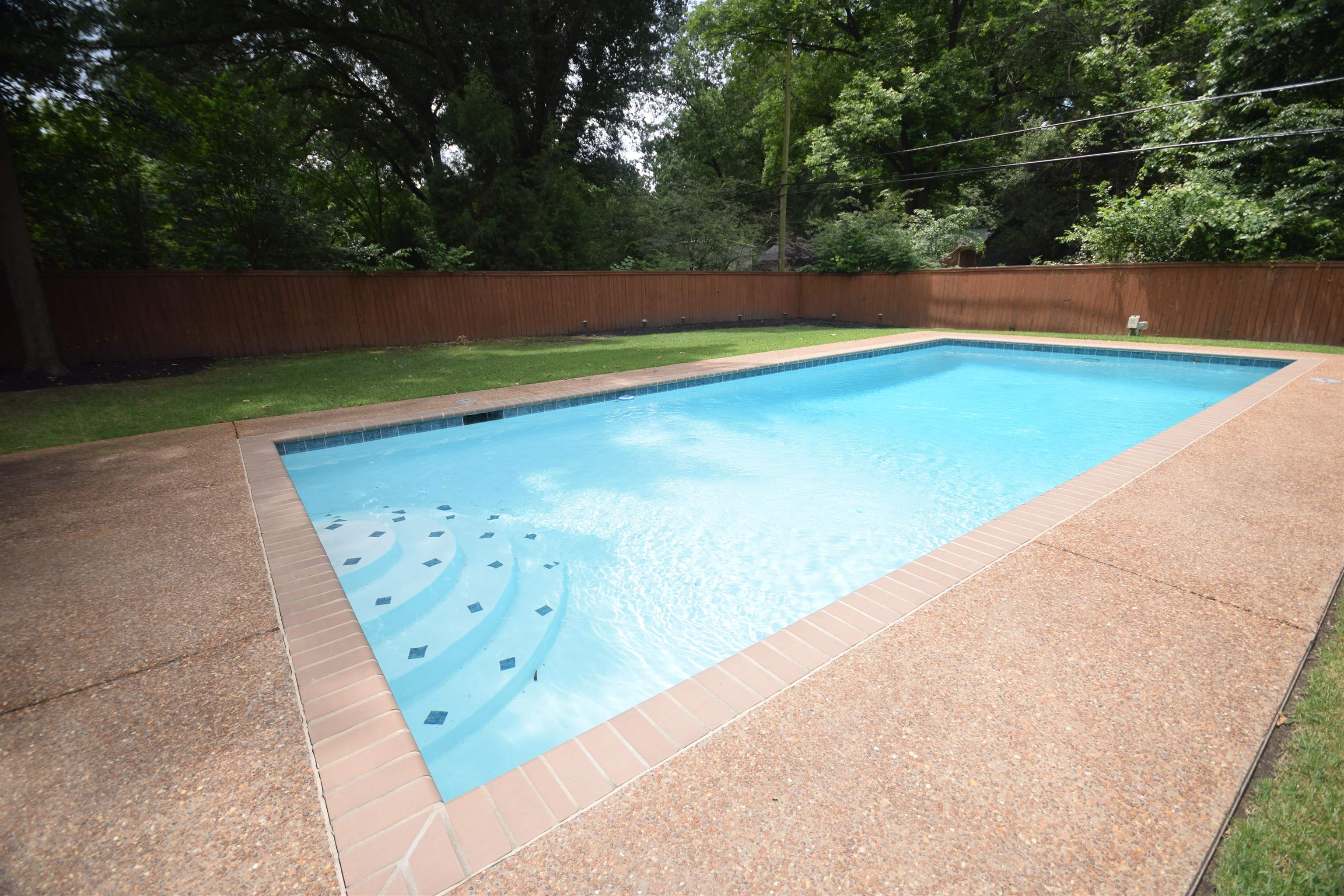 181 South Mendenhall Road Memphis, TN 38117 - Photo 23 of 25 a view of a swimming pool and trees in the background