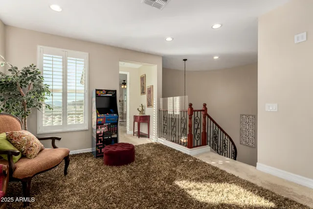 a living room with furniture a fireplace and a large window