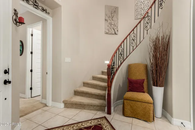 a living room with fireplace furniture and a rug