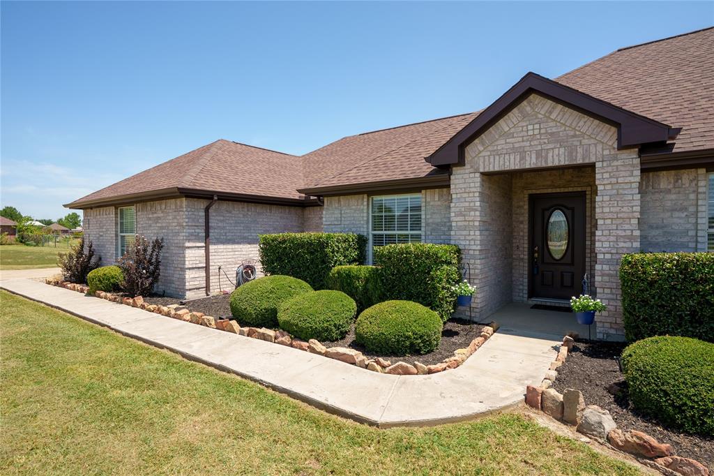1908 Assembly Road Fort Worth, TX 76179 - Photo 1 of 1 Light-colored brick exterior with dark trim and a brown shingle roof