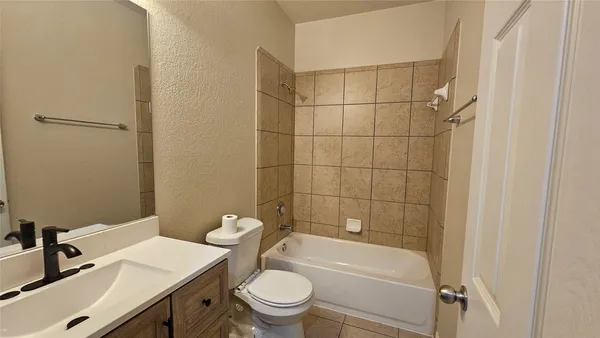 a bathroom with a sink toilet vanity and shower
