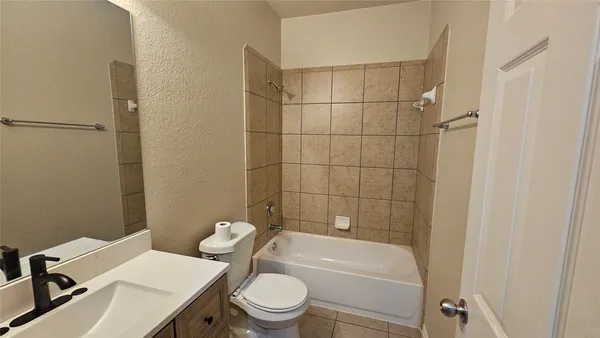 a white toilet sitting next to a bath tub