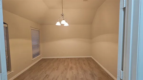 a view of a room with wooden floor and breakfast area