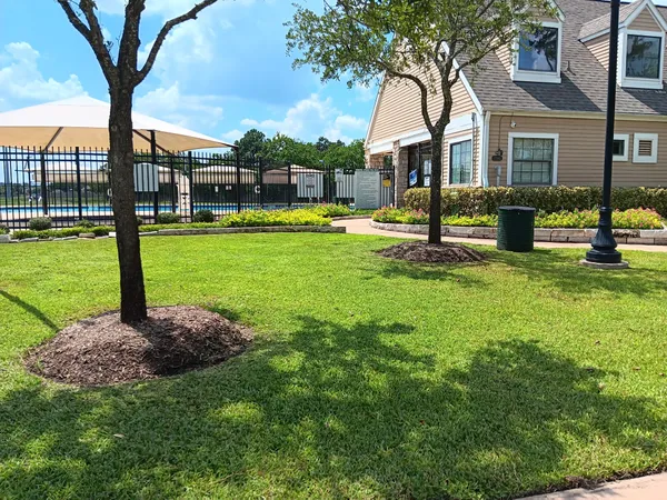 a view of a house with backyard and sitting area
