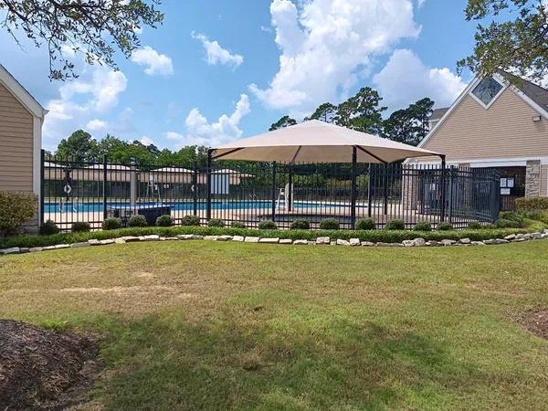a view of a swimming pool with an outdoor seating and a yard