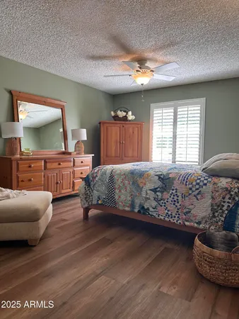 a bedroom with furniture and a large window