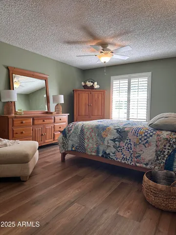 a bedroom with furniture and a large window