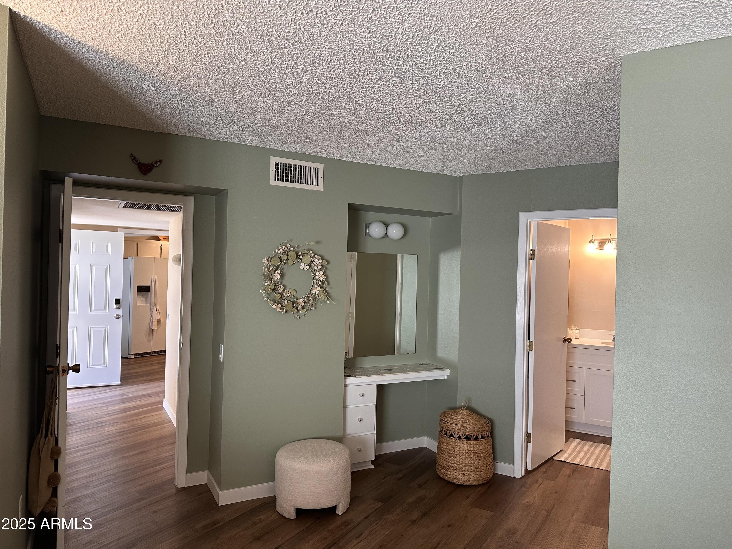 17247 North 106th Avenue Sun City, AZ 85373 - Photo 12 of 30 a view of a hallway with wooden floor and a bathroom