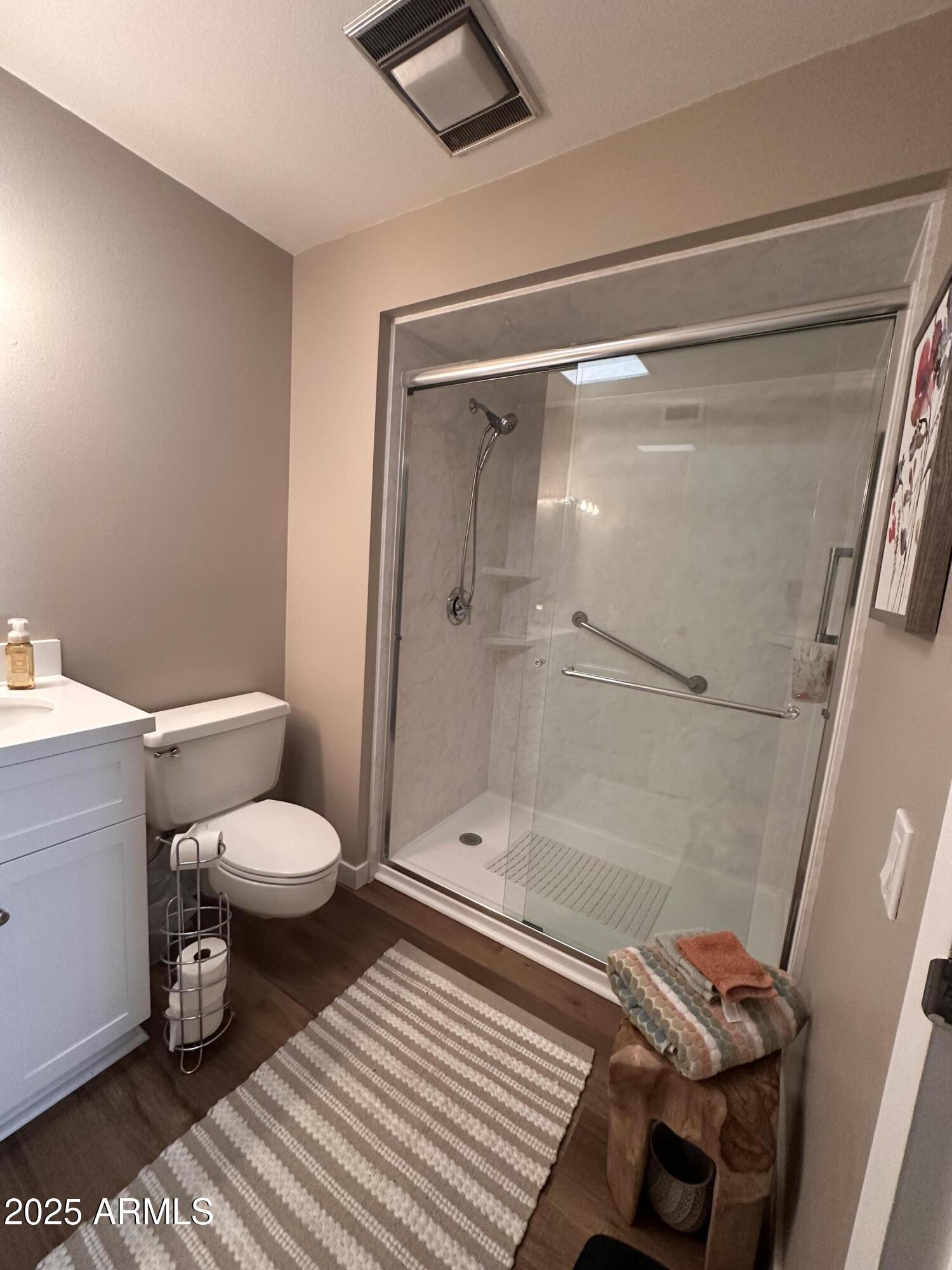 17247 North 106th Avenue Sun City, AZ 85373 - Photo 13 of 30 a bathroom with a toilet and a shower