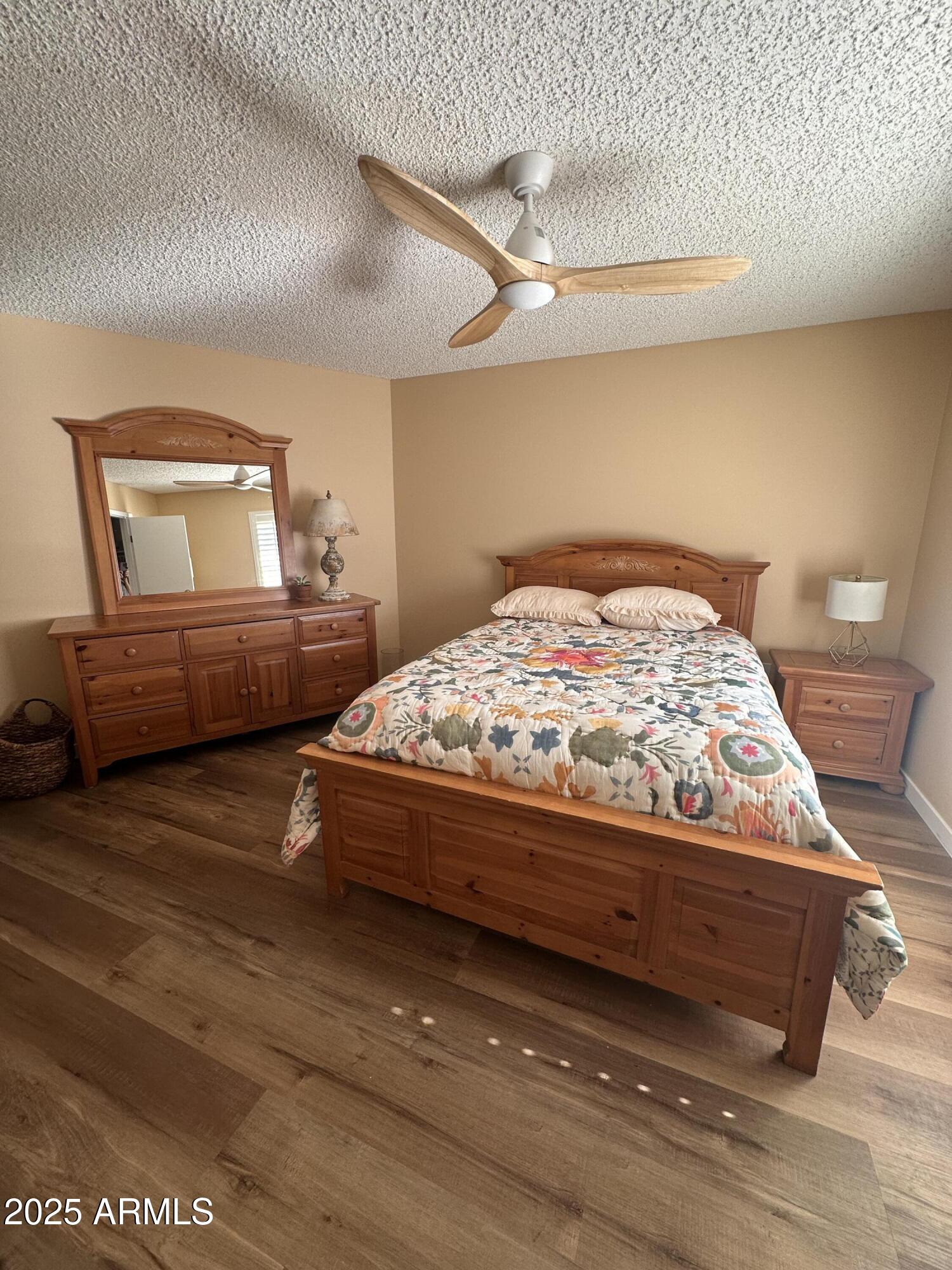 17247 North 106th Avenue Sun City, AZ 85373 - Photo 14 of 30 a bedroom with a bed and dresser
