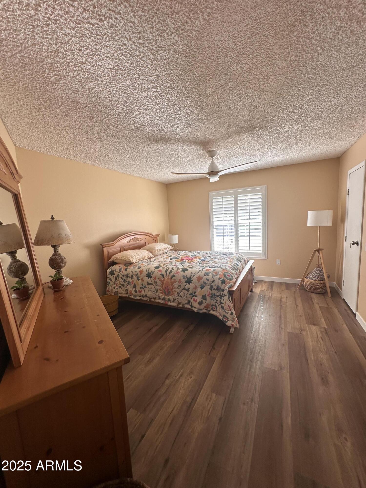 17247 North 106th Avenue Sun City, AZ 85373 - Photo 15 of 30 a bedroom with two beds and a large window