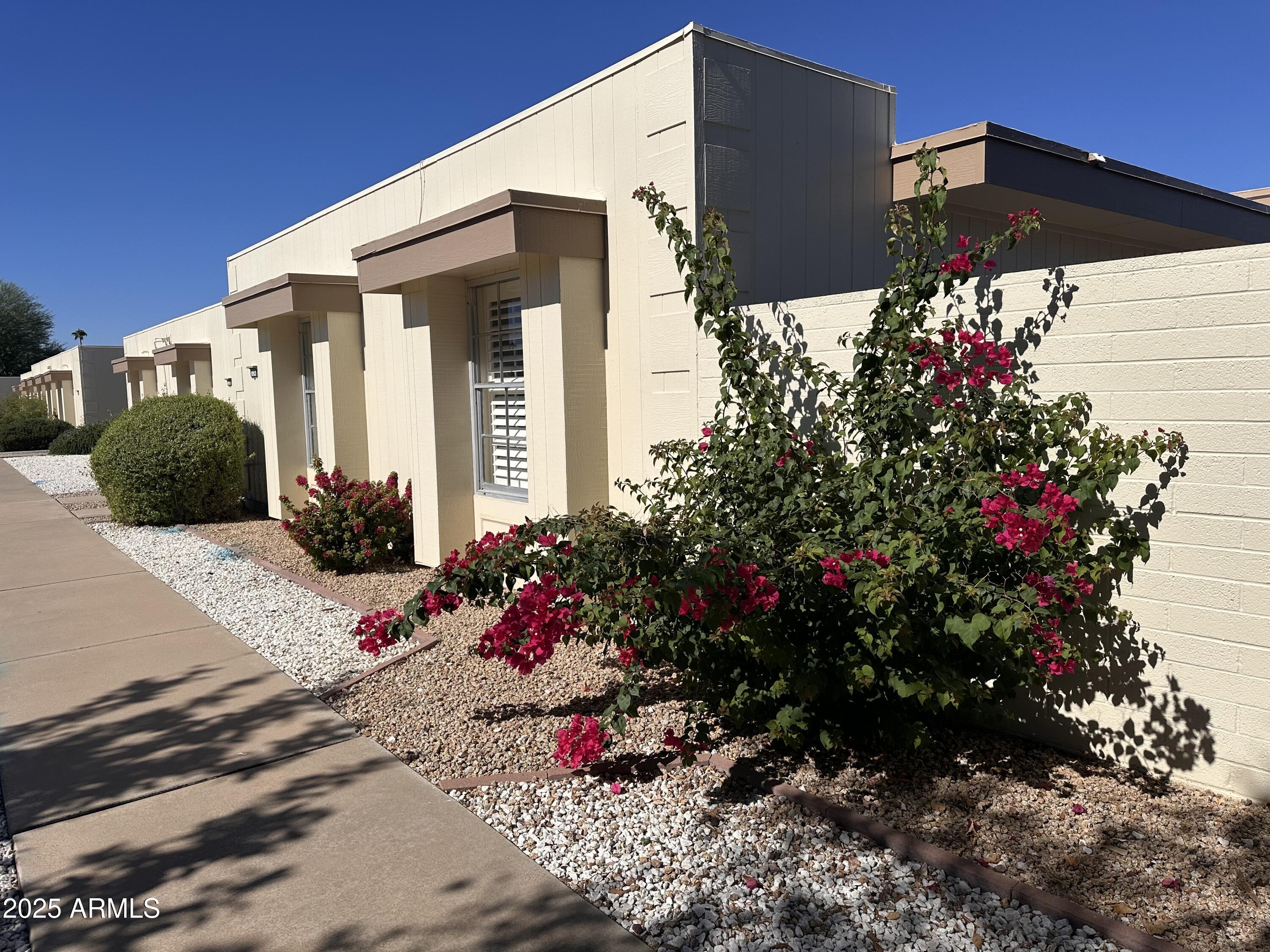 17247 North 106th Avenue Sun City, AZ 85373 - Photo 2 of 30 a view of a house with a flower garden