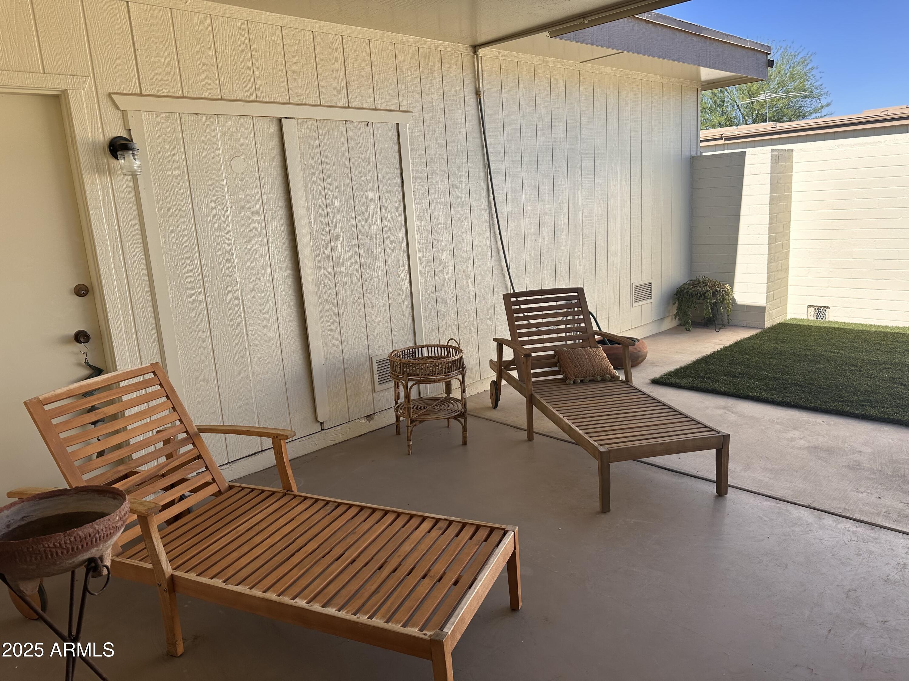 17247 North 106th Avenue Sun City, AZ 85373 - Photo 21 of 30 a living room with furniture a rug and a window