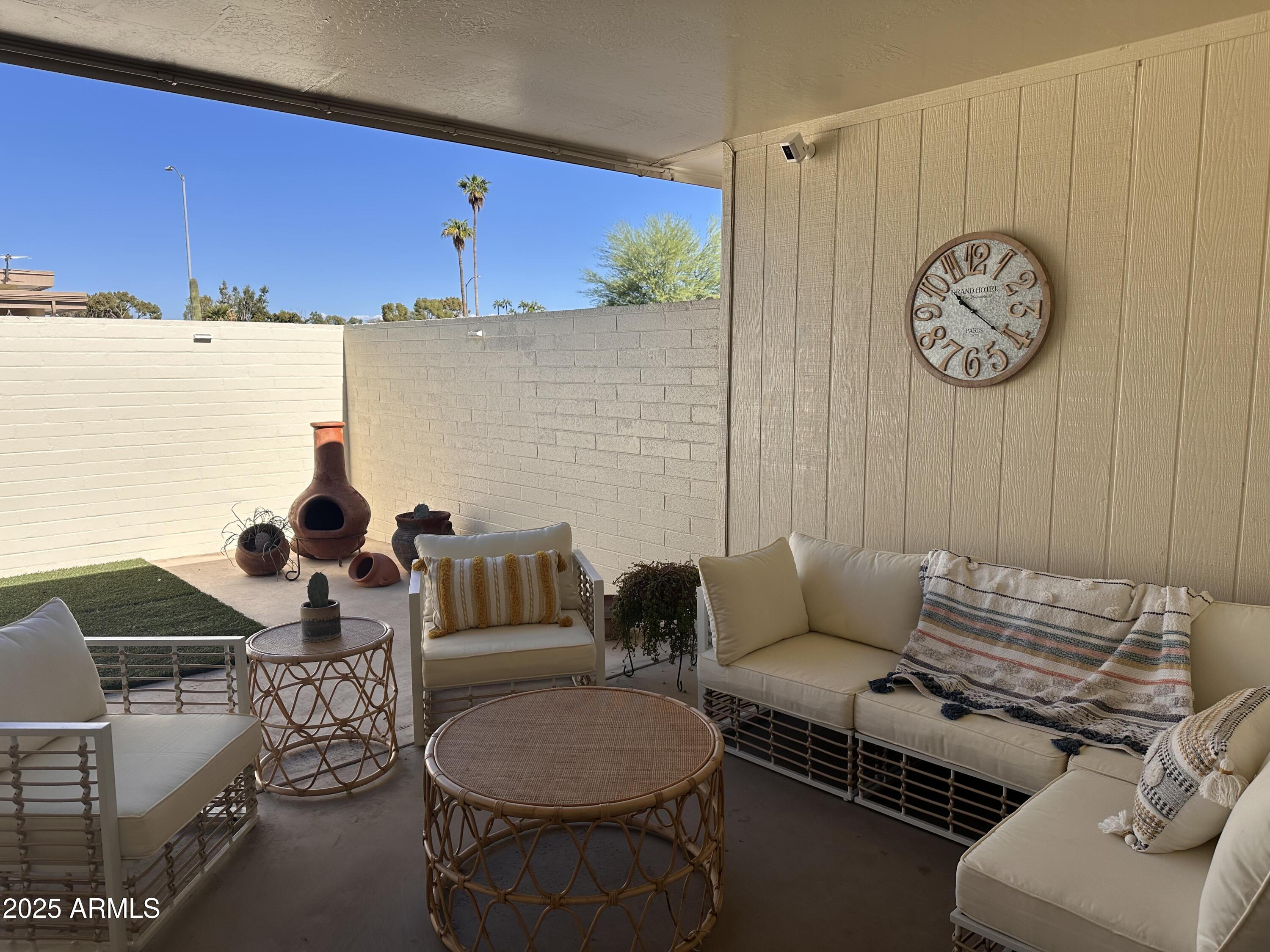 17247 North 106th Avenue Sun City, AZ 85373 - Photo 27 of 30 a living room with furniture a clock and a window