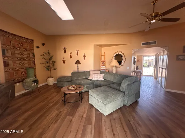 a living room with furniture and wooden floor