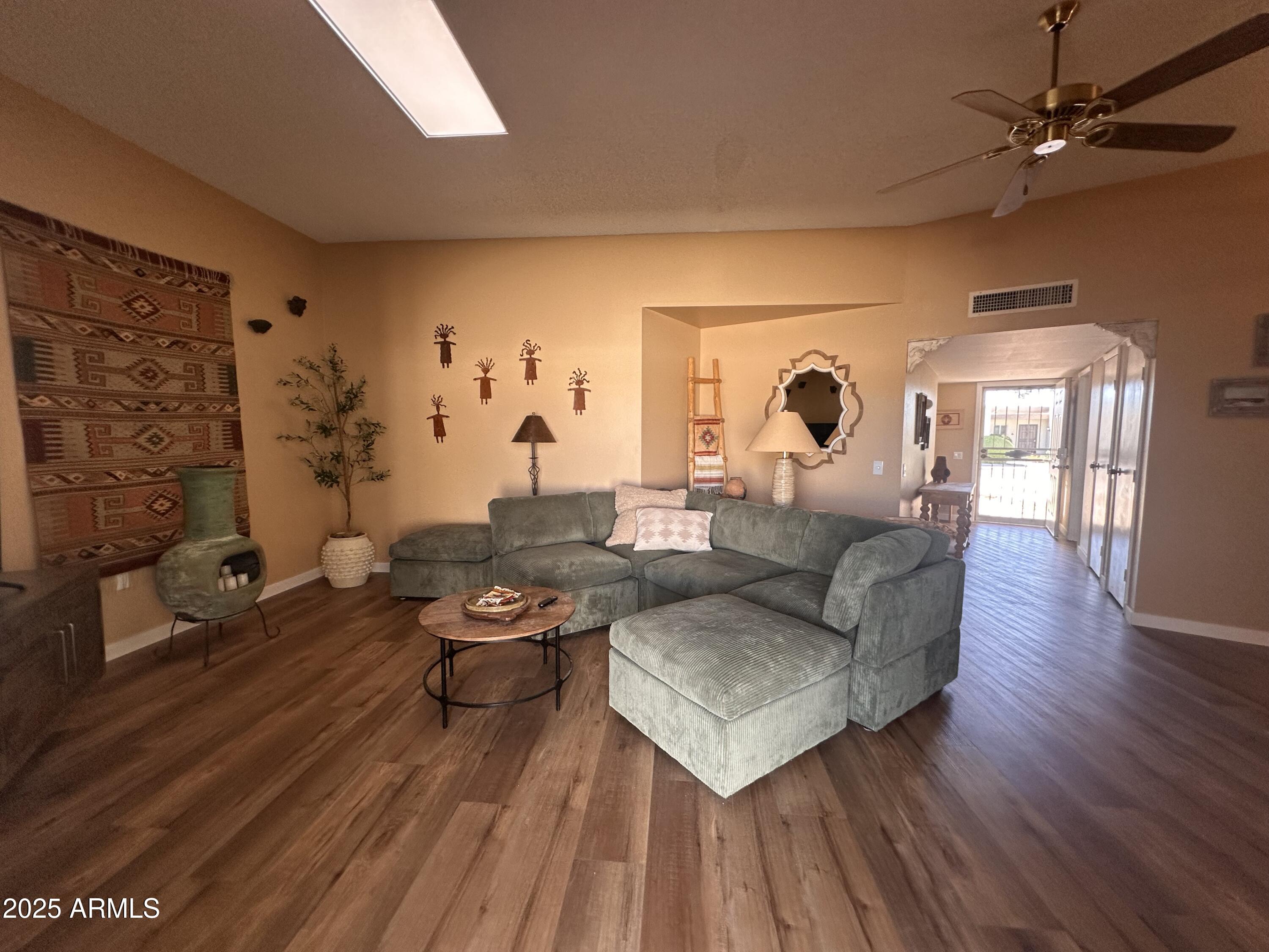 17247 North 106th Avenue Sun City, AZ 85373 - Photo 3 of 30 a living room with furniture and wooden floor