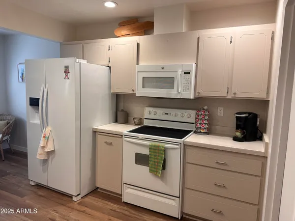 a white refrigerator freezer sitting inside of a kitchen