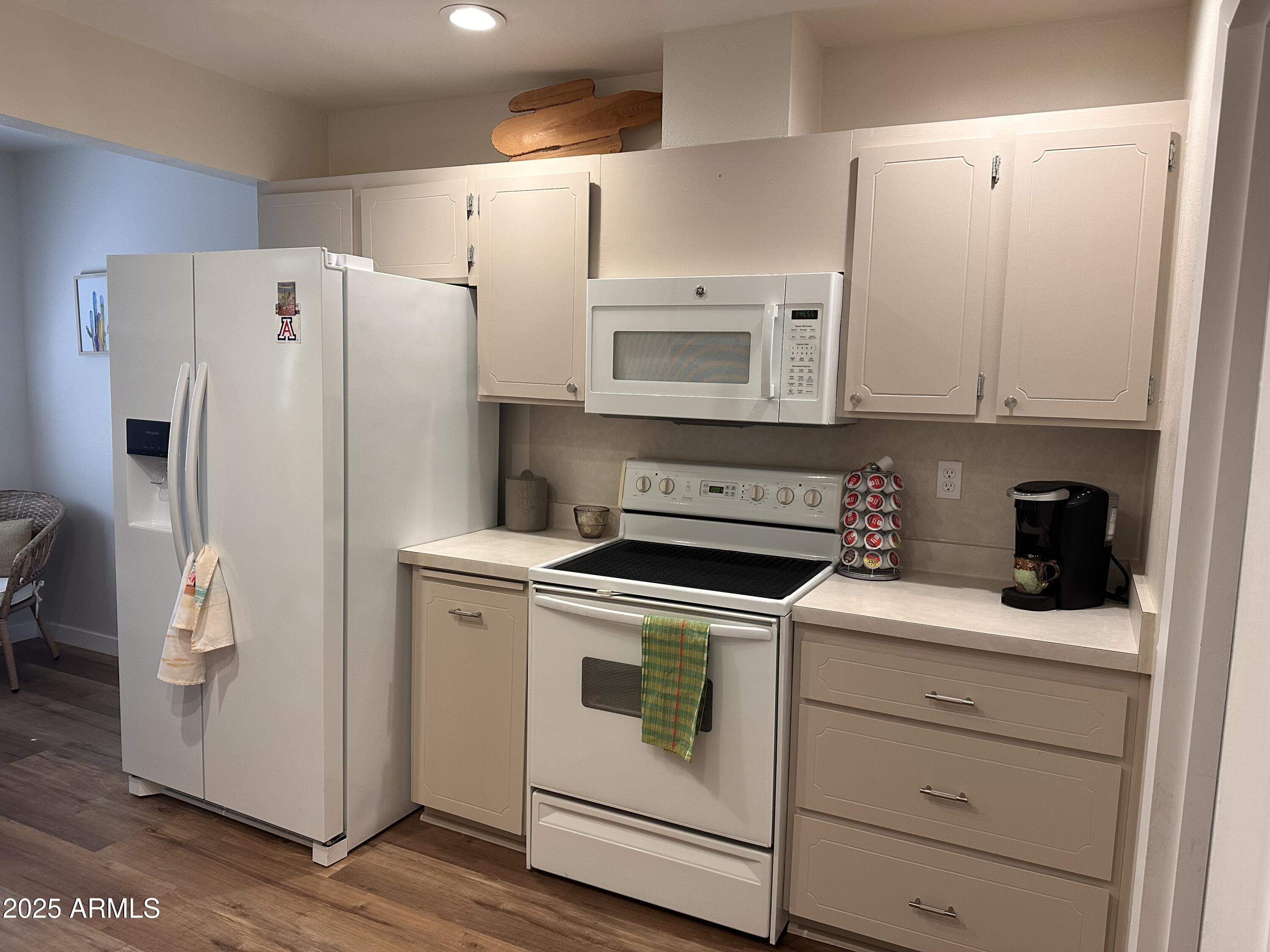 17247 North 106th Avenue Sun City, AZ 85373 - Photo 7 of 30 a white refrigerator freezer sitting inside of a kitchen