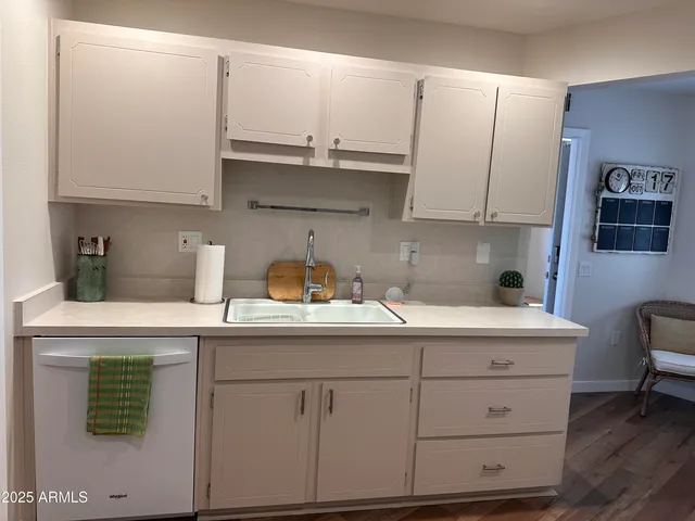 a kitchen with cabinets appliances a sink and a counter space