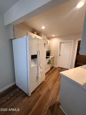 a kitchen with stainless steel appliances a refrigerator and a stove top oven
