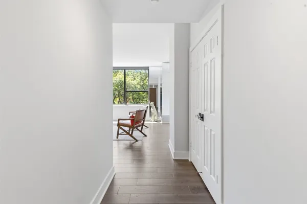 a view of a hallway with a dining room and livingroom