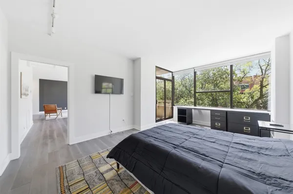 a bedroom with a large bed and a large window