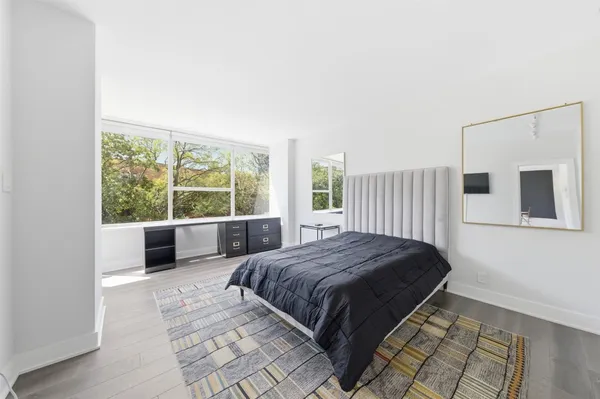 a bedroom with a large bed and a large window