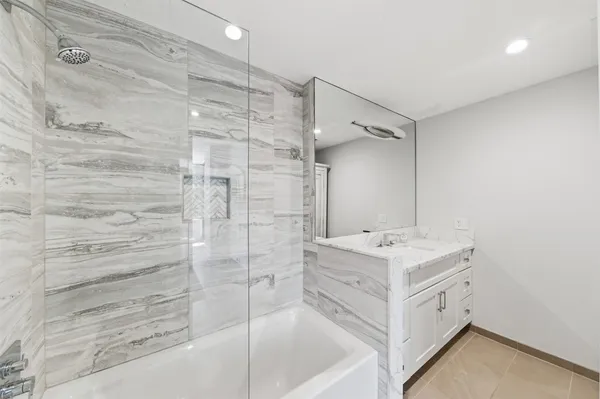 a bathroom with a bathtub and a sink
